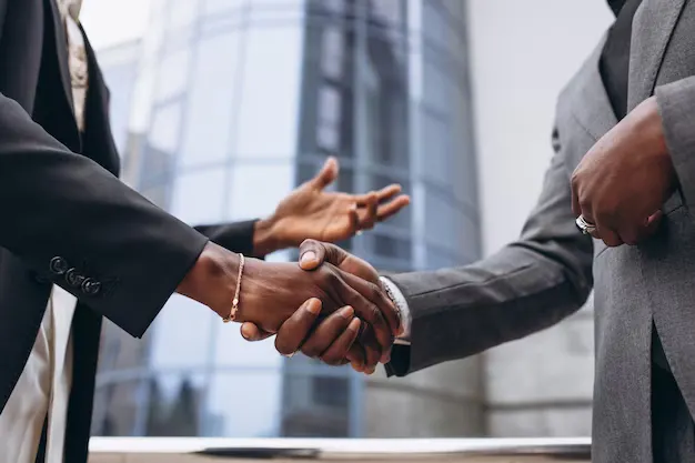 Trusted marketing partnership handshake for Georgetown MA businesses with FBK Marketing